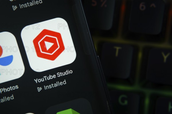 Dhaka, Bangladesh- 27 July 2025: Close-up of smartphone screen showing the youtube studio app icon with a dark interface