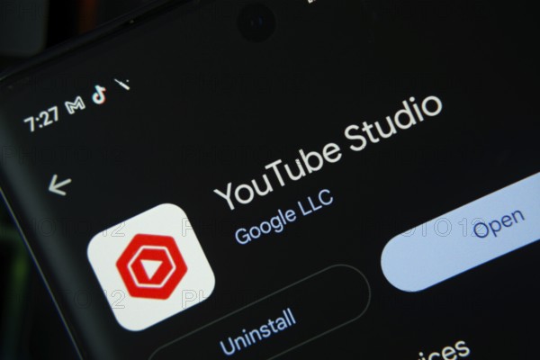Dhaka, Bangladesh- 27 July 2025: Screen displaying youtube studio app with open and uninstall options, dark interface