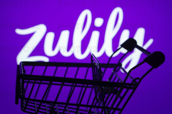 Dhaka, Bangladesh- 03 July 2025: Silhouette of a shopping cart in front of the Zulily logo, symbolizing ecommerce and online shopping