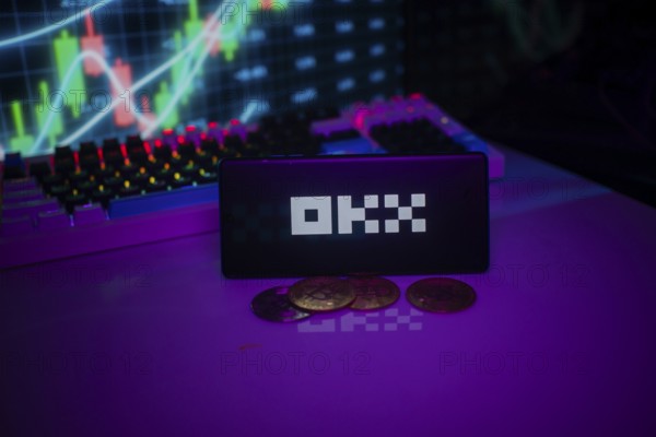 OKX logo displayed amidst purple hue with coins and trading graphs visible behind