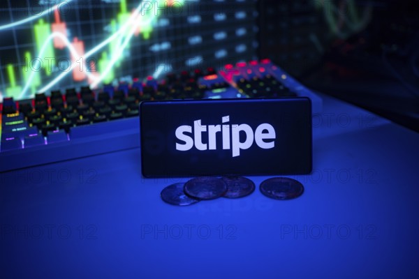 Stripe shown on a smartphone surrounded by coins and trading visuals