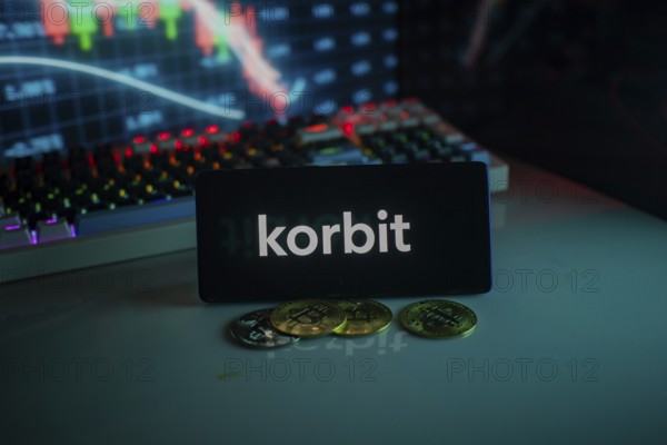 Korbit logo with cryptocurrency coins and market graph in neon-lit setting