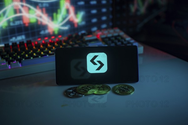 Cryptocurrency logo and coins set against a market graph in a neon setting