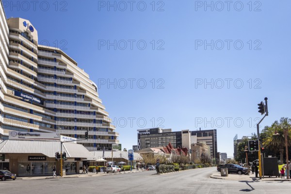 Modern downtown Windhoek, Namibia - 11 August, 2025: with tall contemporary buildings, wide streets, moving cars, and a clear blue sky