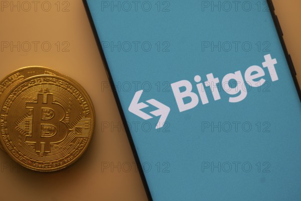 Bitget logo on a blue smartphone screen next to a Bitcoin on an orange backdrop