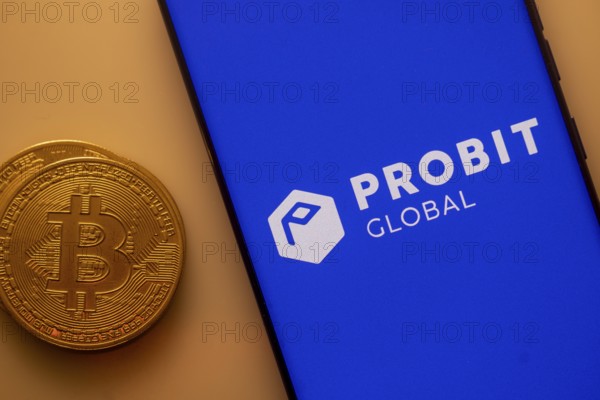 Bitcoin besides a smartphone displaying Probit Global app on blue background