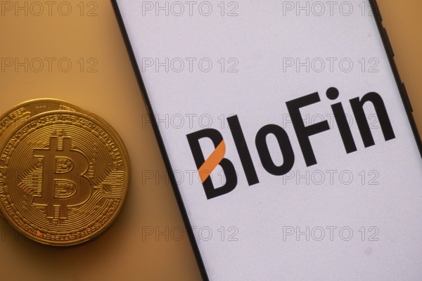Bitcoin placed beside a smartphone with BloFin logo on a white background