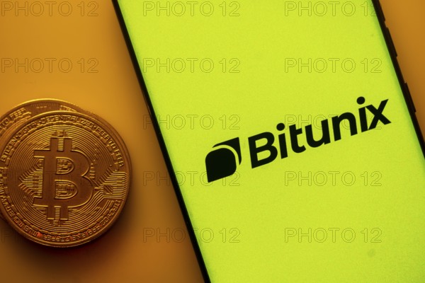 Yellow Bitunix screen with Bitcoin coin, symbolizing cryptocurrency platform
