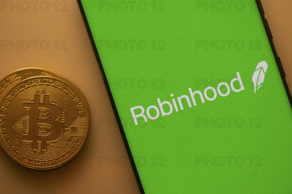 Green Robinhood screen with Bitcoin coin, representing cryptocurrency trading