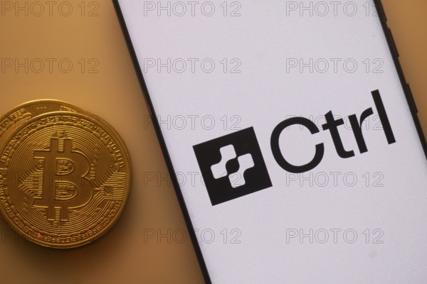 Bitcoin and Ctrl logo displayed on a smartphone with orange ambient lighting