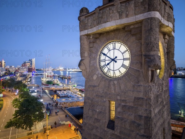 Evening atmosphere at the Landungsbrücken with a view of the Elbphilharmonie and the historic sailing ship Rickmers Rickmers as well as the clock tower in the harbour at the blue hour, Hamburg, Germany