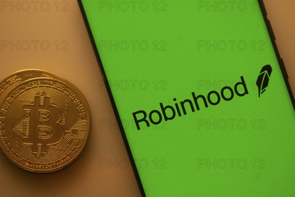 Robinhood logo on a smartphone screen with a Bitcoin coin