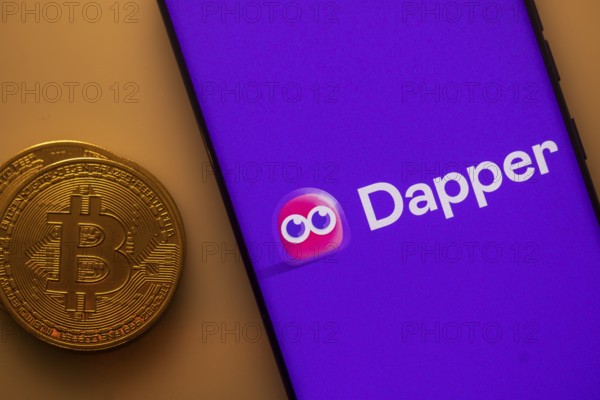 Dapper logo displayed on a smartphone next to a Bitcoin coin