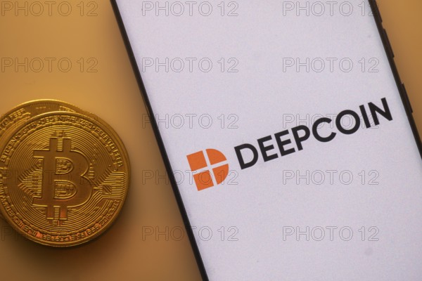Deepcoin logo shows up on a smartphone screen near a Bitcoin coin on an orange background