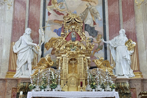 Magnificent baroque altar with golden details and statues, surrounded by ornate frescoes, Minoritenkirche Tulln Lower Austria Austria