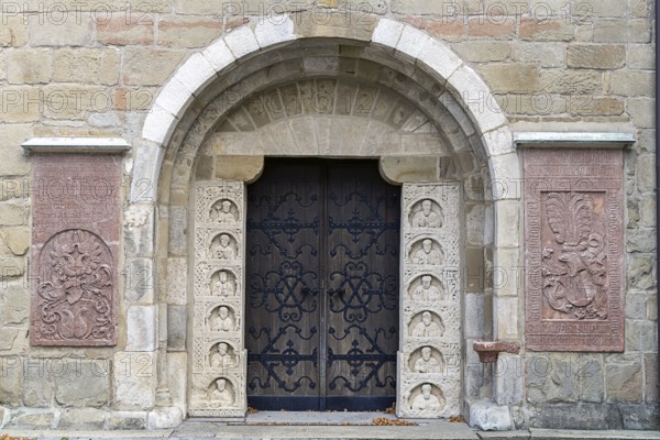 Historic stone door with reliefs and coats of arms, decorated medieval architecture, parish church St.Stephan Tulln Lower Austria Austria