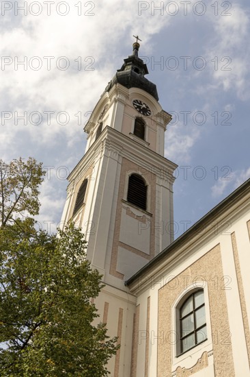 Sublime baroque tower of a church in front of a blue sky with clouds, decorated with baroque details, Minoritenkirche Tulln Lower Austria Austria