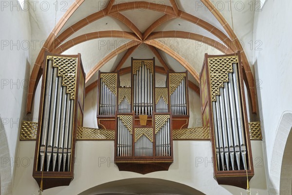 Close-up of an impressive church organ with ornate wooden details and arch structures, parish church of St.Stephan Tulln Lower Austria Austria