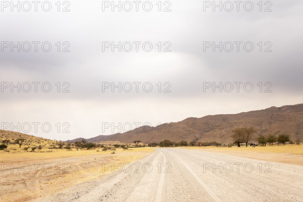 Dirt Road in Solitaire, Namibia, located on the edge of the Namib Desert, surrounded by dunes and mountain ranges