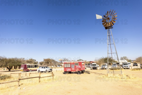 Solitaire's car graveyard in Namibia - 27 August, 2025: features rusted vintage cars near small desert buildings, set against dunes and mountains, capturing desert charm and isolation