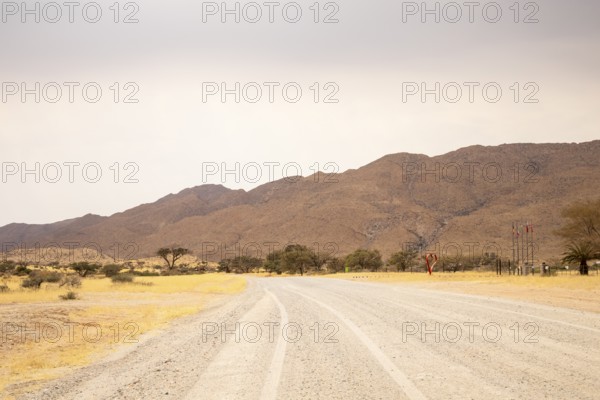 Dirt Road in Solitaire, Namibia, located on the edge of the Namib Desert, surrounded by dunes and mountain ranges