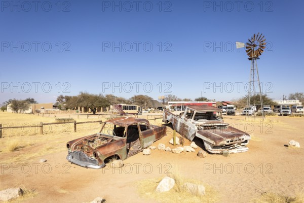 Solitaire's car graveyard in Namibia - 27 August, 2025: features rusted vintage cars near small desert buildings, set against dunes and mountains, capturing desert charm and isolation