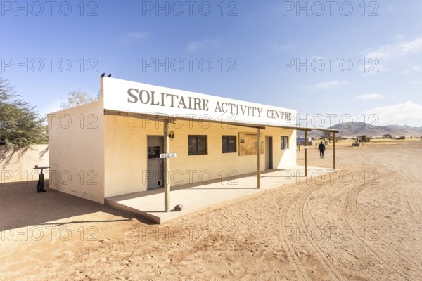 Solitaire Activity Centre in Namibia - 27 August, 2025, surrounded by golden sand dunes and rugged mountains under a clear sky