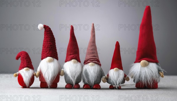 Group of christmas gnomes with red hats and white beards standing together on gray background, AI generated