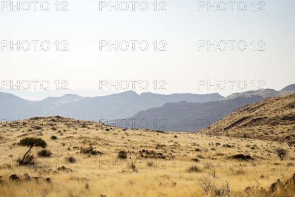 A picnic spot overlooks the vast Namib Desert from Spreetshoogte Pass, with hazy plains, rugged mountains