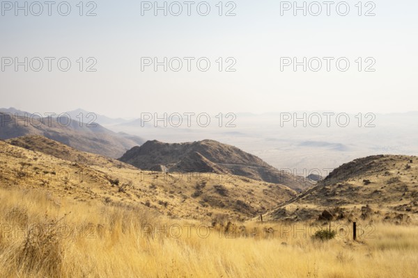 A picnic spot overlooks the vast Namib Desert from Spreetshoogte Pass, with hazy plains, rugged mountains