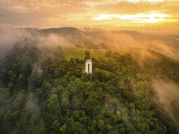 A foggy morning with a tower surrounded by green hills, Schönbergturm, Pfullingen, Swabian Alb, Germany
