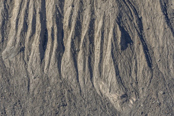 The earth's surface shows clear stripes and reliefs formed by erosion in dry regions. These natural patterns tell the geological history of the place. Gorner Glacier, Zermatt, Valais, Alps, Swiss