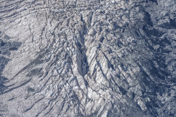 The mountainous landscape reveals impressive glaciers with ice formations and gleaming reflections in the morning light. Details of rocky outcrops add to the natural beauty. Gorner Glacier, Zermatt, Valais, Alps, Swiss