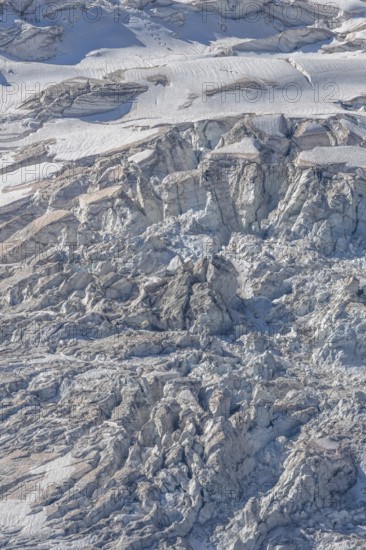 The mountainous landscape reveals impressive glaciers with ice formations and gleaming reflections in the morning light. Details of rocky outcrops add to the natural beauty. Gorner Glacier, Zermatt, Valais, Alps, Swiss