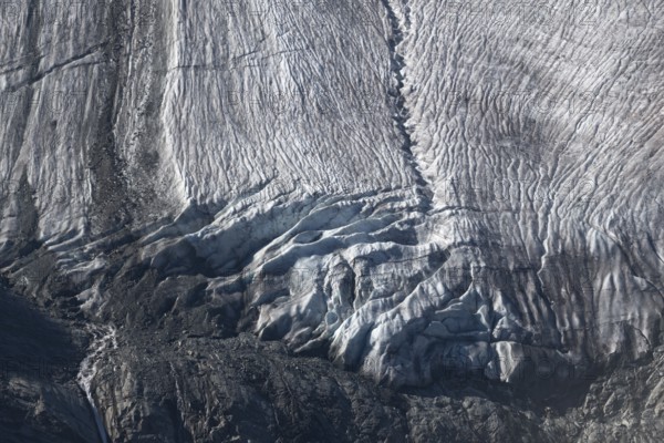 Impressive scene shows lines and textures on residual ice cream in mountains. Daylight emphasises the beauty of this unique, cold landscape. Gorner Glacier, Zermatt, Valais, Alps, Swiss