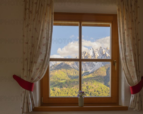 View through a window to the Dolomites in the foreground a small vase with meadow flowers on the windowsill, San Candido, Val Pusteria, Sesto Dolomites, Dolomites, South Tyrol, Italy