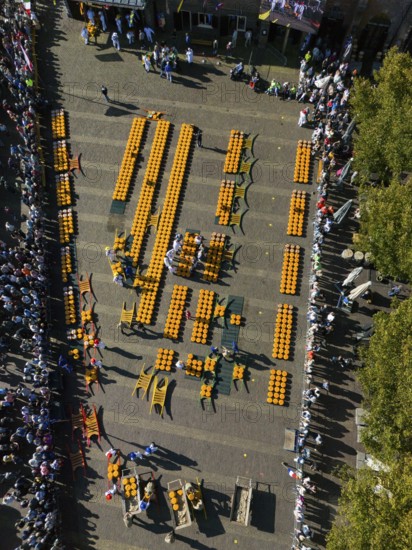 Aerial view of a busy market square with lots of cheese wheels and people at a sunny festival, aerial view, cheese, cheese market, Alkmaar, Alkmar, Noord-Holland, North Holland, Netherlands