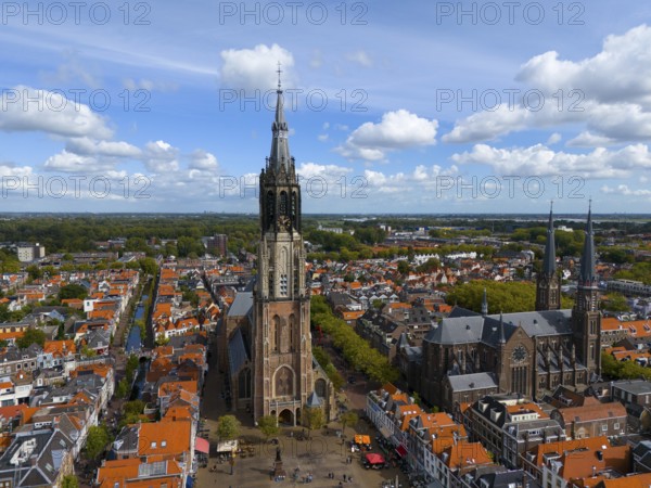 Historic church with high towers in a city with red roofs and clear skies, aerial view, Nieuwe Kerk, New Church, on the right Maria van Jessekerk, market square, Delft, Province of South Holland, Zuid-Holland, Netherlands