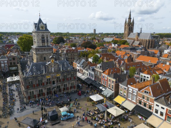 View of the city centre with town hall and lively market square full of people, aerial view, town hall, on the right in the background Oude Kerk, Old Church, market square, Delft, Province of South Holland, Zuid-Holland, Netherlands