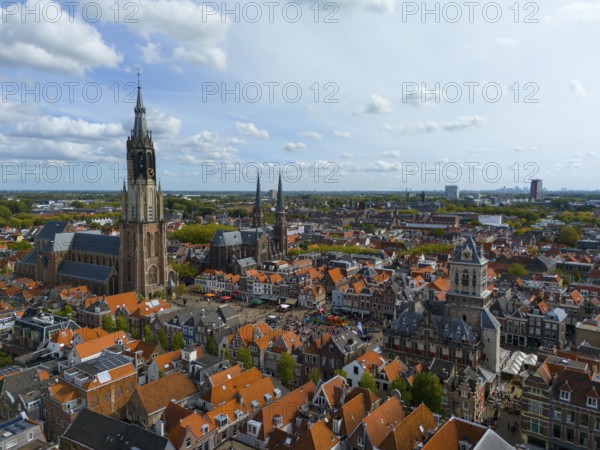 View of the city centre with several churches and red roofs on a cloudy day, aerial view, Nieuwe Kerk, New Church, to the right Maria van Jessekerk, town hall, market square, Delft, Province of South Holland, Zuid-Holland, Netherlands