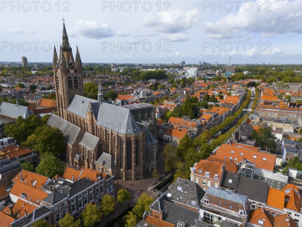 View of the historic city centre with large church and red roofs under a cloudy sky, aerial view, Oude Kerk, Old Church, Market Square, Delft, Province of South Holland, Zuid-Holland, Netherlands