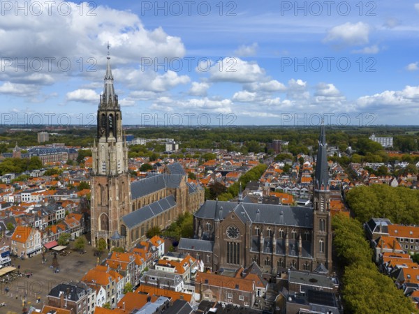 City view with two churches and numerous red roofs under a cloudy sky, aerial view, Nieuwe Kerk, New Church, on the right Maria van Jessekerk, Market Square, Delft, Province of South Holland, Zuid-Holland, Netherlands