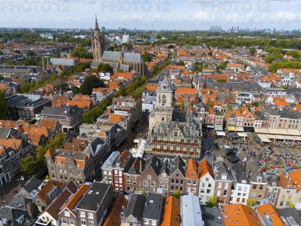 Market square with historic town hall surrounded by red roofs and lively atmosphere, aerial view, town hall, left in the background Oude Kerk, Old Church, market square, Delft, Province of South Holland, Zuid-Holland, Netherlands
