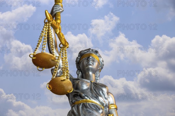 (Photomontage) Close-up of a Justitia in front of a blue sky