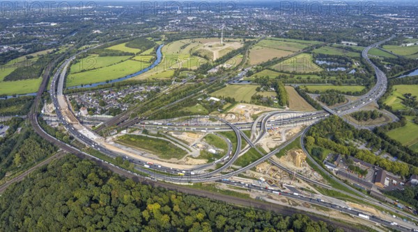 Aerial view, motorway junction Kaiserberg with construction site, motorway A40 and A3, behind energy park Styrumer Ruhrbogen with wind turbine, Duissern, Duisburg, Ruhr area, North Rhine-Westphalia, Germany, motorway, construction work, construction area, building site, building plots, construction project, construction site, DE, Europe, large construction site, aerial view, aerial photography, aerial photography, new construction, road traffic, overview, bird's-eye view, overview