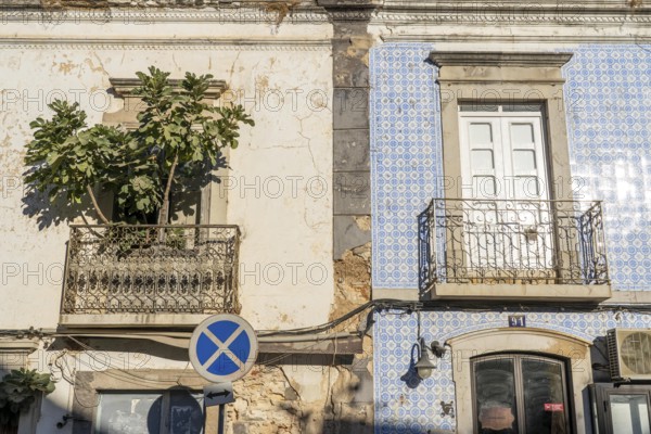 Facade of buildings decorated with tiles, azulejos, coloured tiles on facades, in Tavira, old town, in the east of the Algarve, Portugal