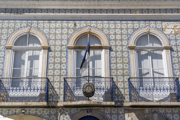 Facade of buildings decorated with tiles, azulejos, coloured tiles on facades, in Tavira, old town, in the east of the Algarve, Portugal