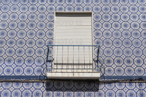Facade of buildings decorated with tiles, azulejos, coloured tiles on facades, in Tavira, old town, in the east of the Algarve, Portugal