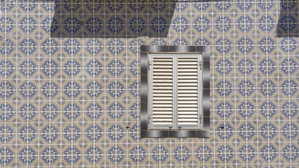 Facade of buildings decorated with tiles, azulejos, coloured tiles on facades, in Tavira, old town, in the east of the Algarve, Portugal