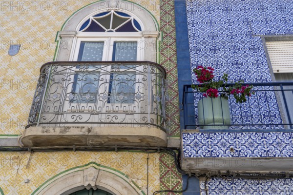 Facade of buildings decorated with tiles, azulejos, coloured tiles on facades, in Tavira, old town, in the east of the Algarve, Portugal